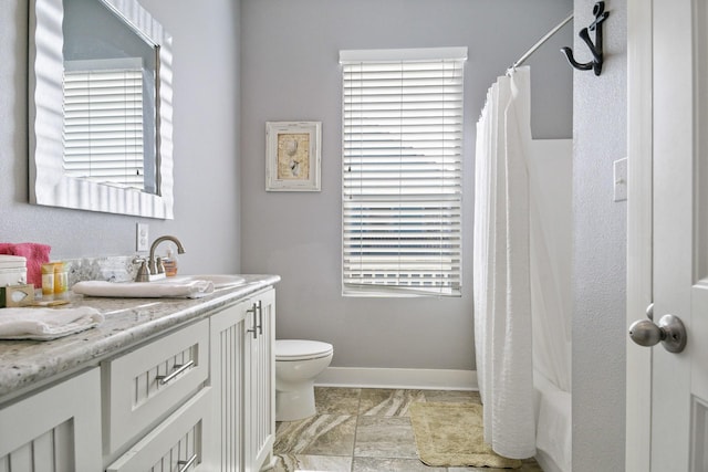 full bathroom featuring vanity, shower / bathtub combination with curtain, toilet, and a wealth of natural light