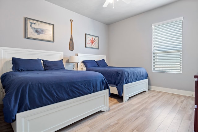 bedroom featuring multiple windows, ceiling fan, and light hardwood / wood-style floors