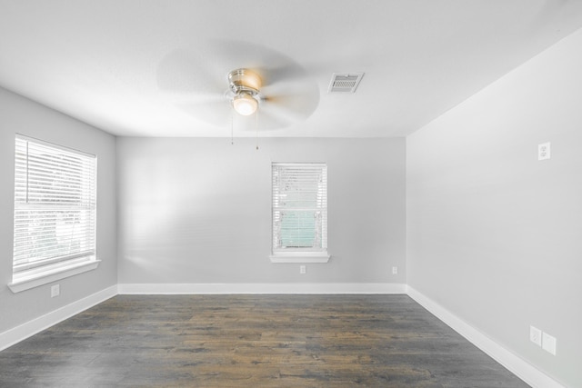 unfurnished room with ceiling fan and dark wood-type flooring