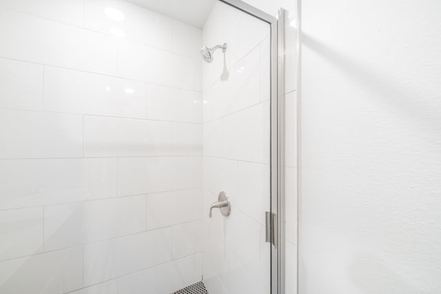 bathroom with a shower with door