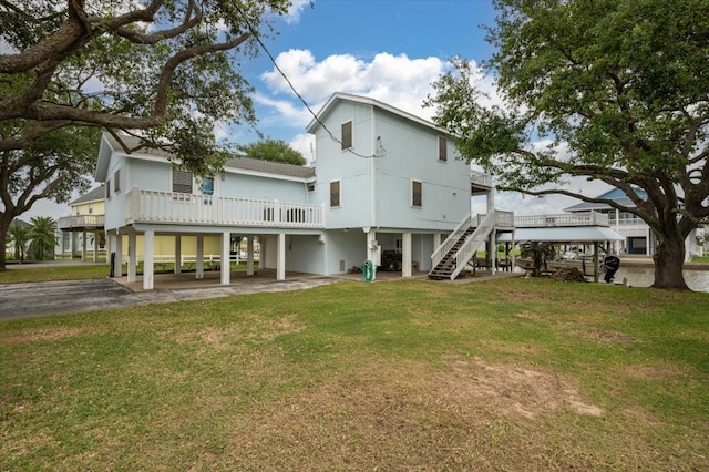 back of property with a deck and a lawn