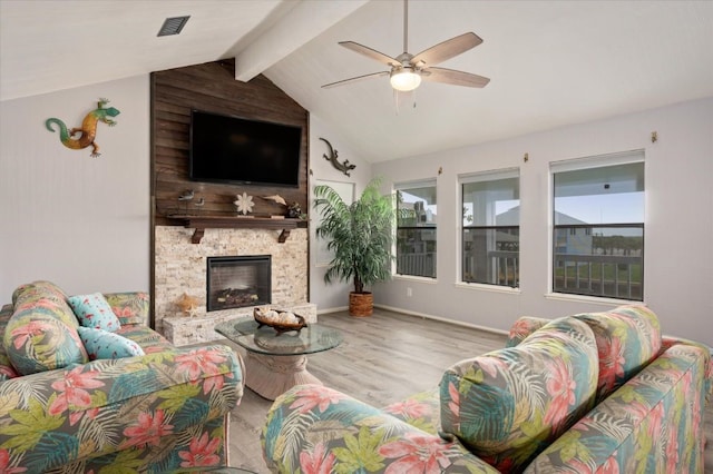 living room featuring ceiling fan, vaulted ceiling with beams, a fireplace, wood-type flooring, and wooden walls