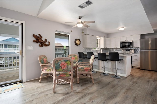 dining area featuring ceiling fan and light hardwood / wood-style flooring