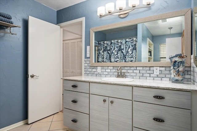 bathroom featuring backsplash, tile flooring, and vanity