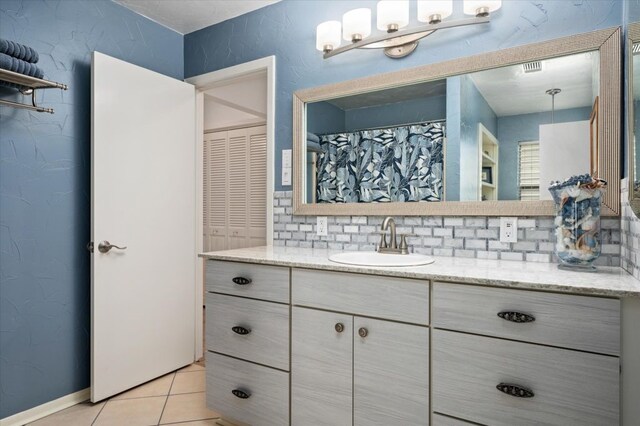1220 Waterways Dr, Crystal Beach, TX 77650 - full bathroom featuring tile patterned floors, backsplash, and vanity