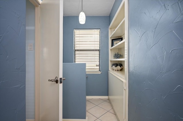 1220 Waterways Dr, Crystal Beach, TX 77650 - laundry room featuring light tile patterned flooring, baseboards, and built in features