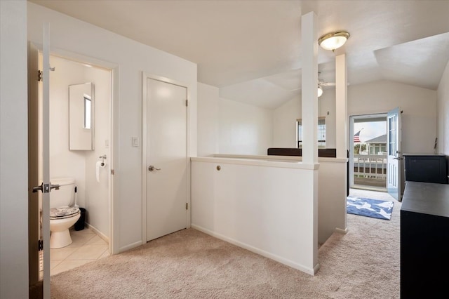 hallway featuring light carpet and lofted ceiling