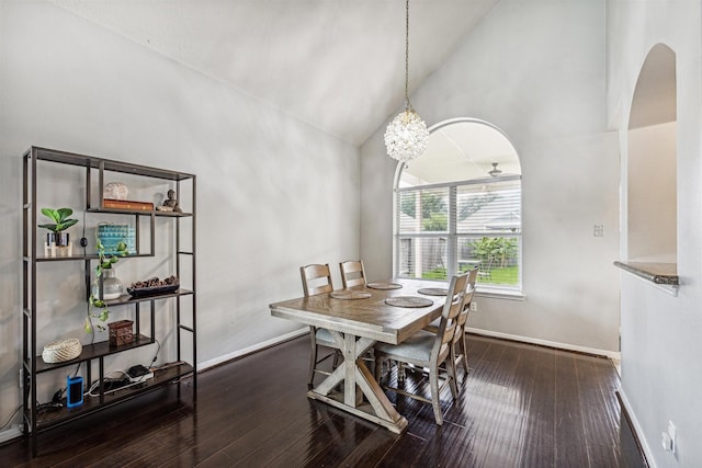 dining space with dark hardwood / wood-style flooring and high vaulted ceiling