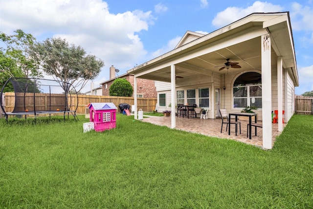 view of yard featuring ceiling fan, a patio, and a trampoline