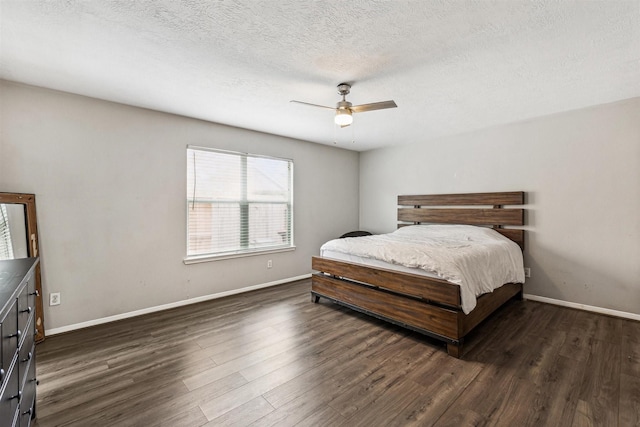 bedroom featuring ceiling fan, dark hardwood / wood-style flooring, and a textured ceiling