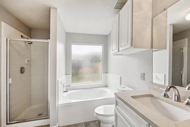 full bathroom featuring vanity, toilet, a textured ceiling, and independent shower and bath