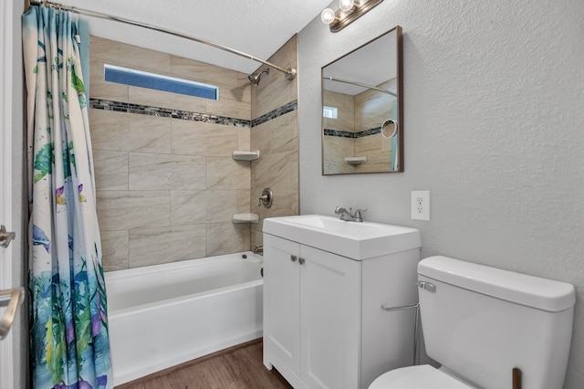 full bathroom featuring shower / bathtub combination with curtain, a textured ceiling, wood-type flooring, vanity, and toilet