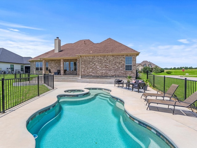 view of swimming pool featuring a yard, a patio area, fence, and an in ground hot tub