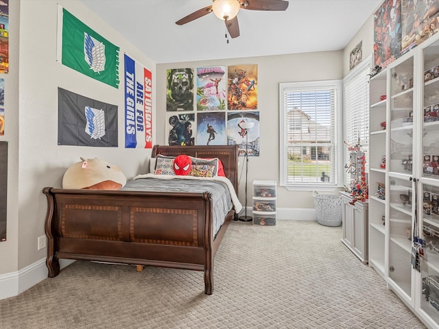 bedroom with ceiling fan, carpet flooring, and baseboards