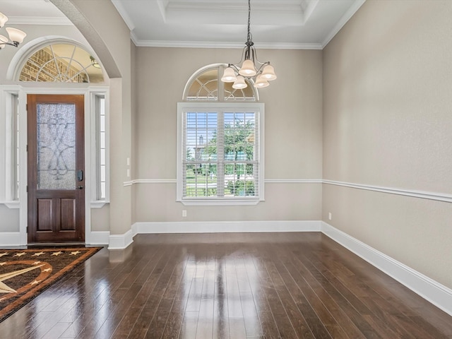 foyer with dark wood-style floors, crown molding, a notable chandelier, a raised ceiling, and baseboards