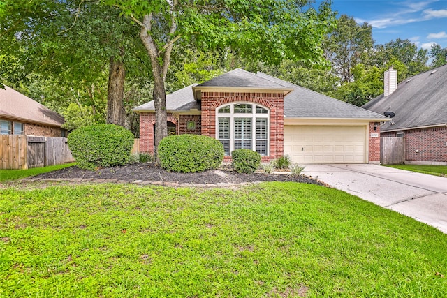 view of front of home featuring a garage and a front yard