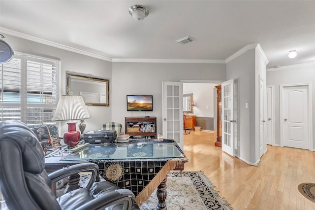 office area with ornamental molding, light hardwood / wood-style floors, and french doors