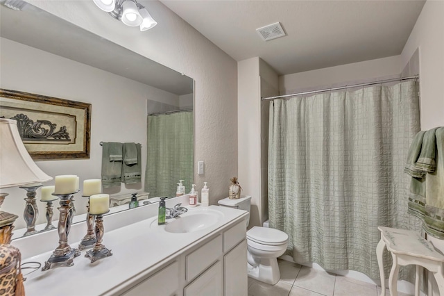 bathroom with vanity, toilet, and tile patterned flooring