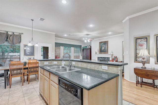 kitchen with an island with sink, dishwashing machine, sink, and dark stone counters