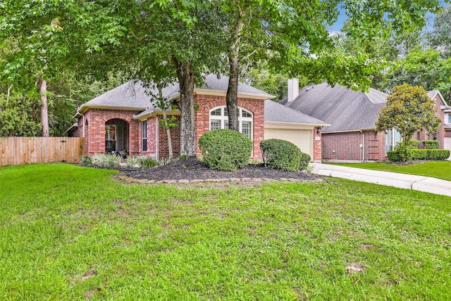 view of front facade featuring a garage and a front lawn