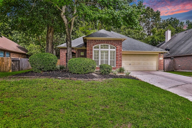 view of front of home featuring a garage and a yard