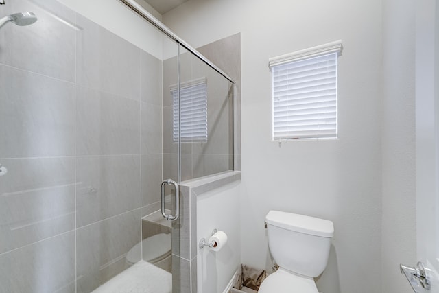 bathroom with walk in shower and toilet