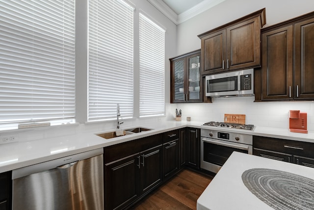 kitchen featuring dark hardwood / wood-style flooring, stainless steel appliances, a healthy amount of sunlight, tasteful backsplash, and sink