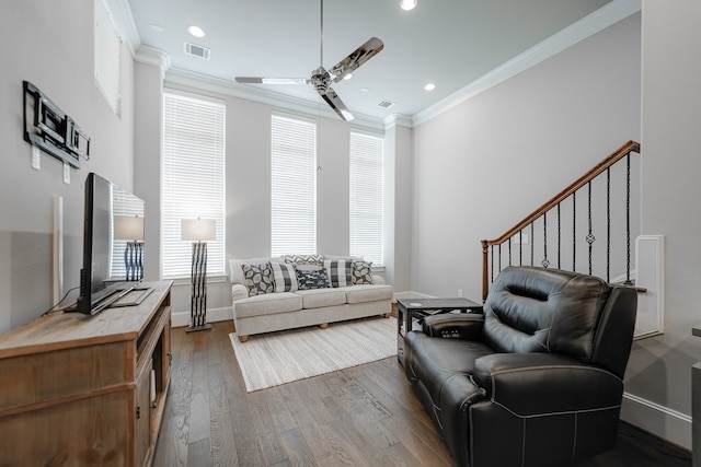 living room featuring crown molding, a wealth of natural light, ceiling fan, and dark hardwood / wood-style flooring