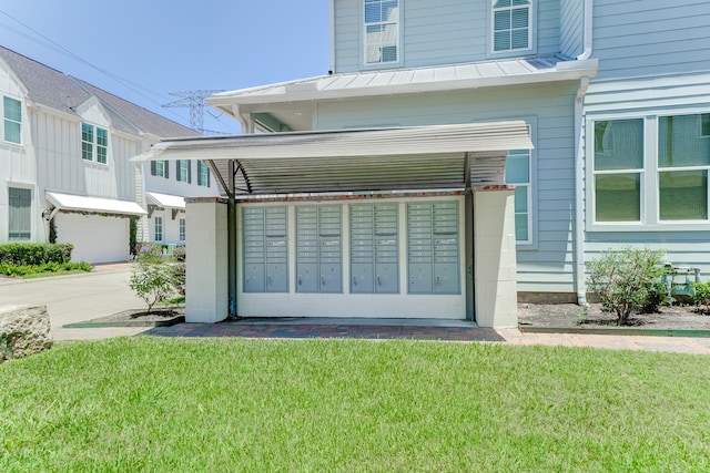 entrance to property featuring a garage and a yard