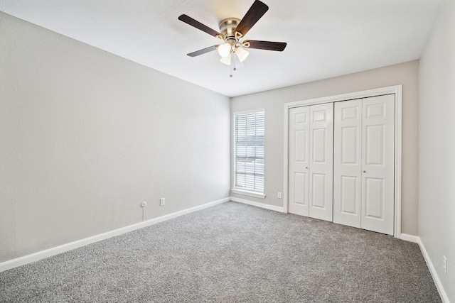 unfurnished bedroom with ceiling fan, carpet floors, and a closet