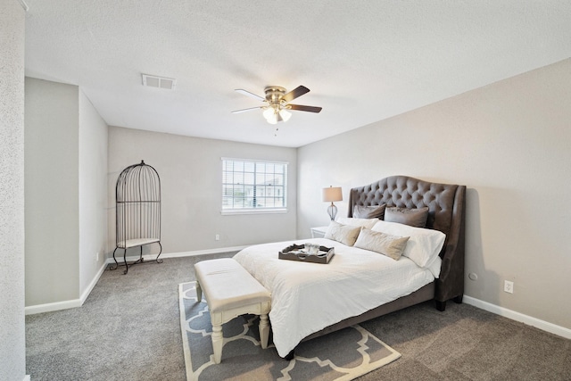 bedroom with carpet, a textured ceiling, and ceiling fan