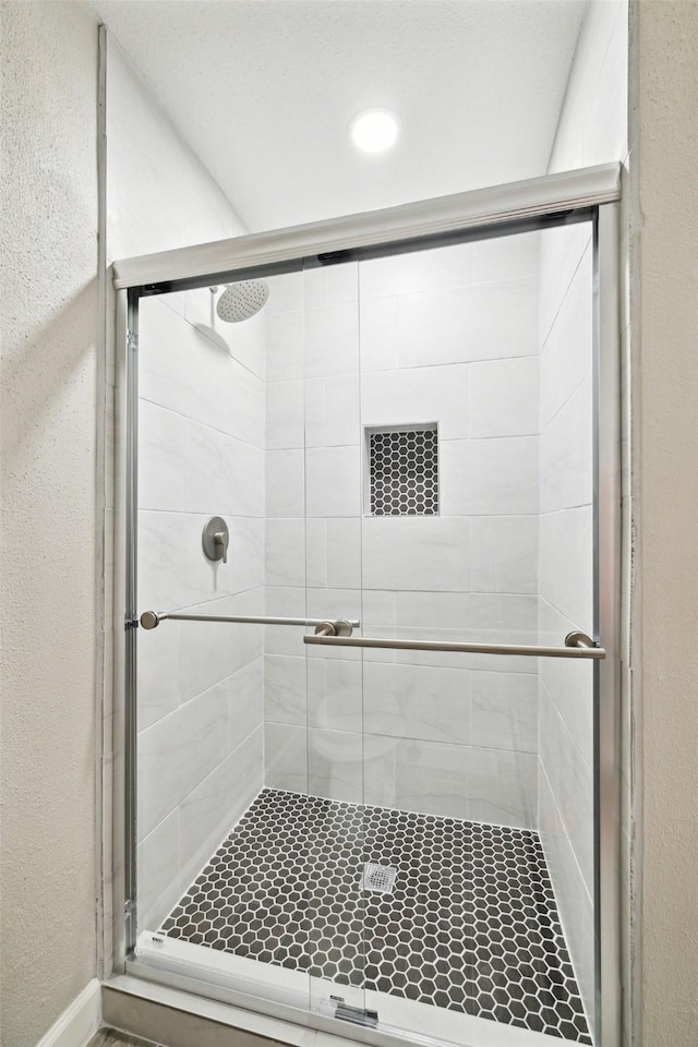 bathroom with a shower with shower door