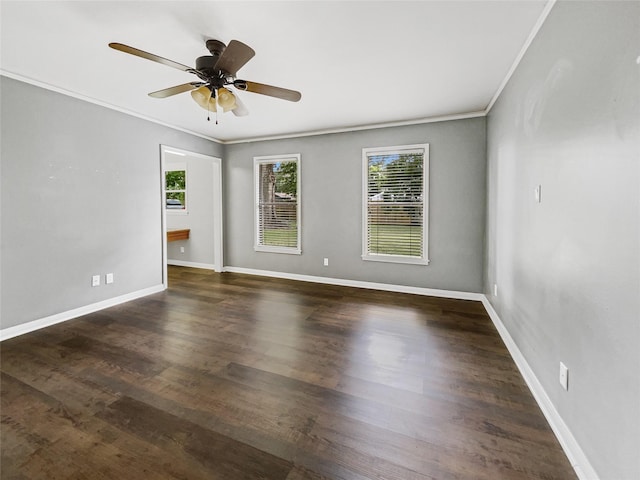 empty room with ceiling fan, crown molding, and dark wood-type flooring