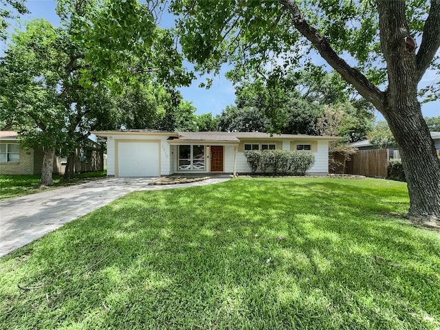 single story home featuring a garage and a front lawn