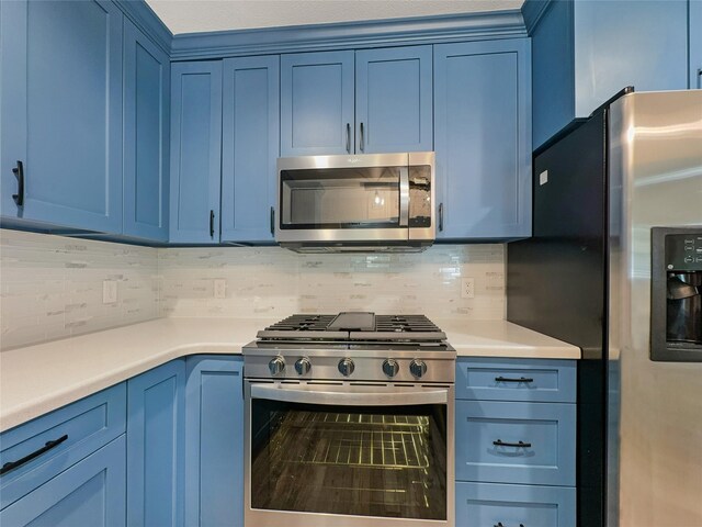 kitchen featuring tasteful backsplash, blue cabinetry, and stainless steel appliances