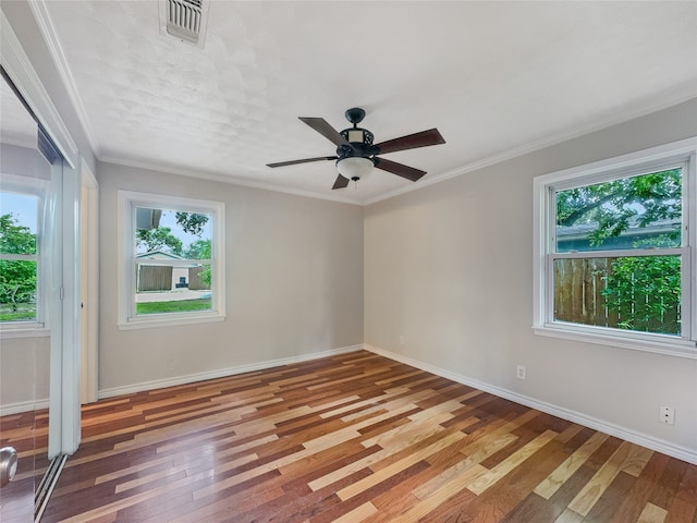 spare room with ceiling fan, a healthy amount of sunlight, and ornamental molding