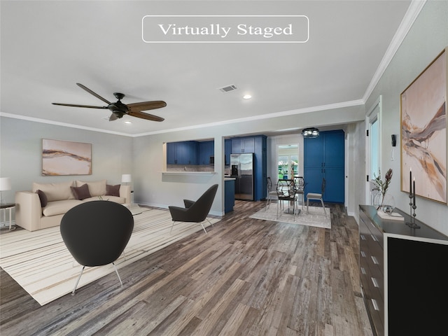 living room featuring ceiling fan, ornamental molding, and wood-type flooring