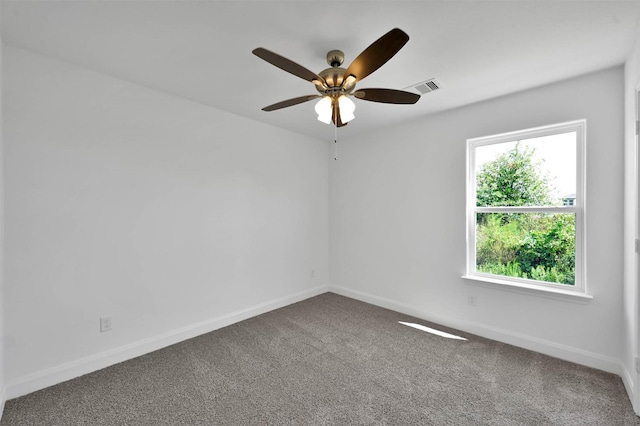 carpeted empty room featuring ceiling fan