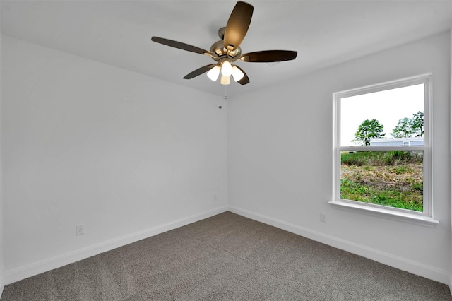 spare room with ceiling fan and carpet