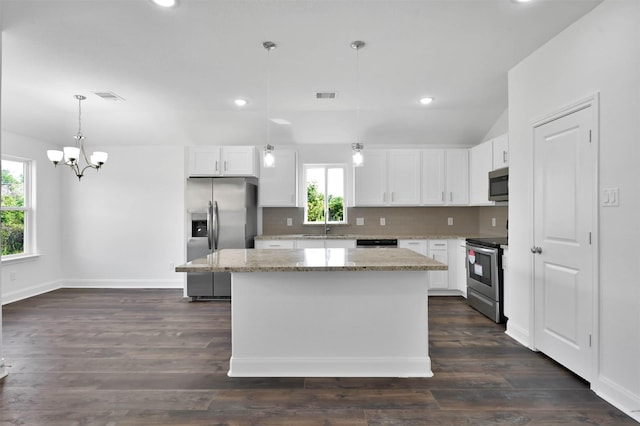 kitchen featuring white cabinets, hanging light fixtures, dark hardwood / wood-style floors, a kitchen island, and stainless steel appliances