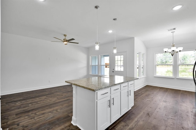 kitchen with decorative light fixtures, dark hardwood / wood-style floors, white cabinetry, and a wealth of natural light