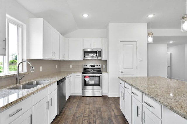 kitchen with sink, dark wood-type flooring, lofted ceiling, white cabinets, and appliances with stainless steel finishes