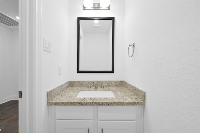 bathroom featuring hardwood / wood-style floors and vanity