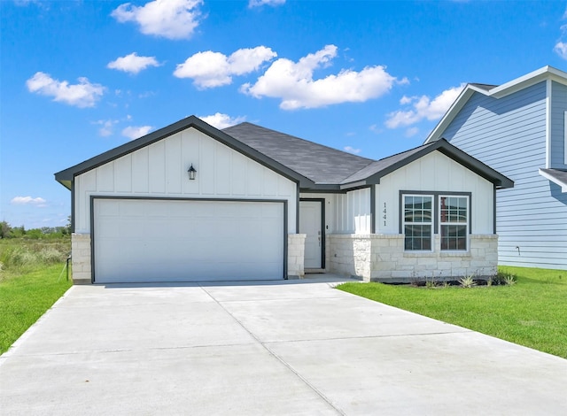 view of front of house with a front yard and a garage