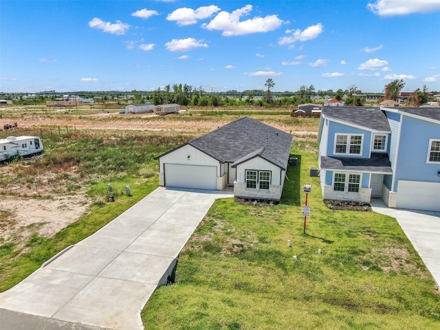 view of front of property with a front lawn and a garage