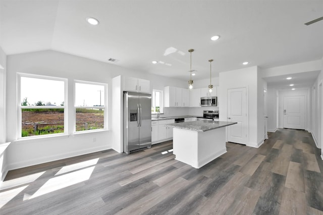 kitchen featuring a center island, hanging light fixtures, hardwood / wood-style floors, white cabinets, and appliances with stainless steel finishes