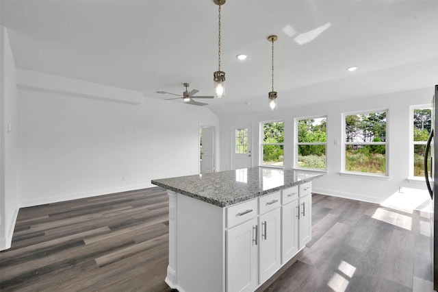 kitchen with a center island, white cabinetry, dark wood-type flooring, and a wealth of natural light