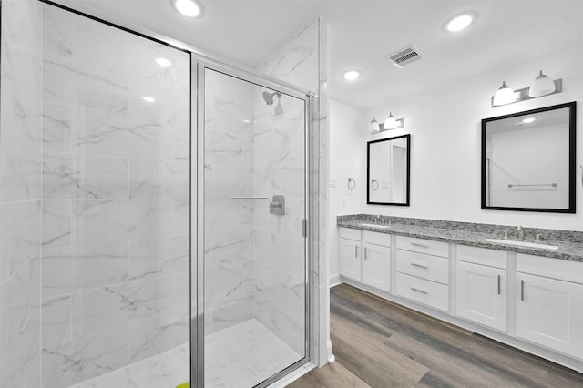 bathroom with vanity, wood-type flooring, and walk in shower