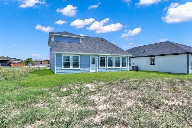 back of house featuring a yard and cooling unit