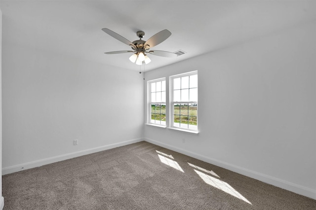 carpeted spare room featuring ceiling fan